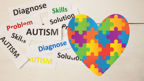 animación de texto de autismo sobre el corazón formado con rompecabezas de conciencia del autismo en blanco