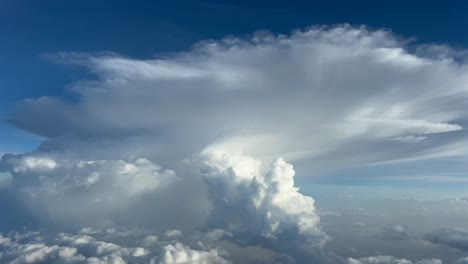 pov flying through a stormy sky with a huge cumulonimbus storm cloud ahead. a pilot’s perspective shot from an airplane cockpit. 4k 60fps