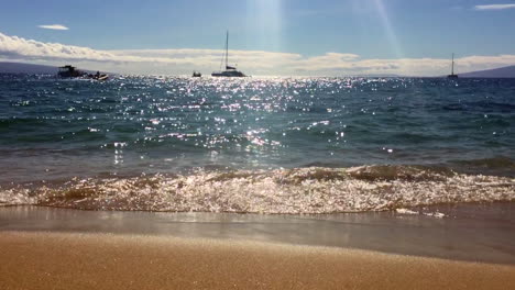 beautiful maui, hawaii sunset, waves, sand, sailboats, and shimmering sun with lanai in distance, hd