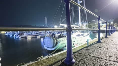 boats and floating dock adjusts to the change in tide - nighttime time lapse