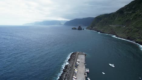 Flight-over-madeira-promenade-along-coastal-hillside-toward-rock-formation