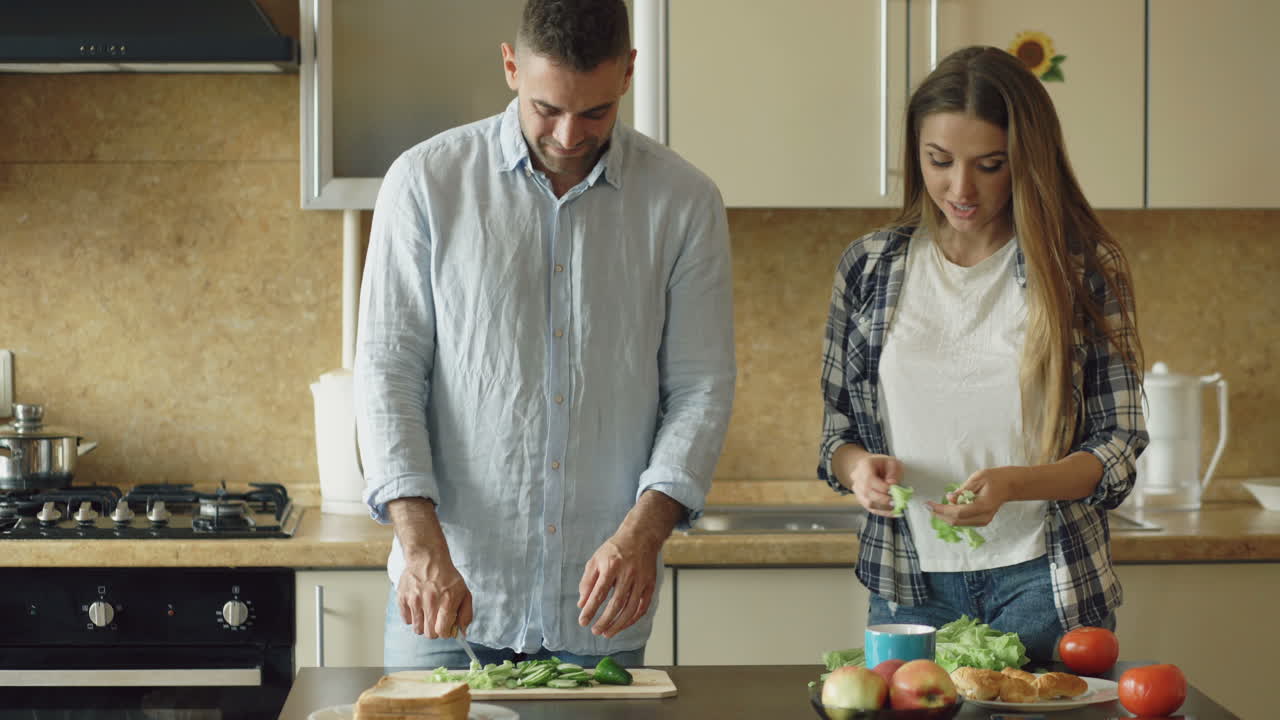 Couple Preparing a Sandwich in the Kitchen