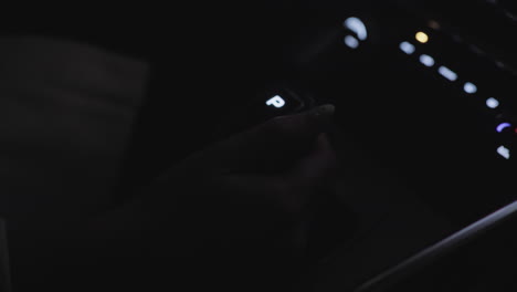 close up of driver hand gripping illuminated gear selector in park mode inside moving car at night, with soft golden light reflecting on hand and dashboard as vehicle begins motion