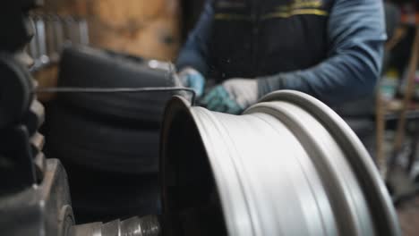 mechanic polishing car wheel