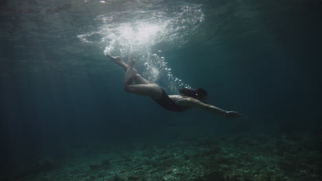 woman freediving underwater