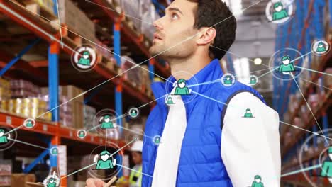 Animation-of-network-of-profile-icons-on-caucasian-male-supervisor-checking-stock-at-warehouse