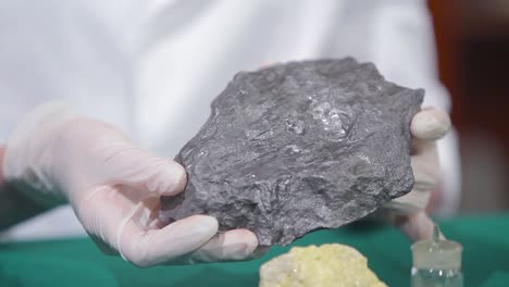 scientist displaying mineral sample