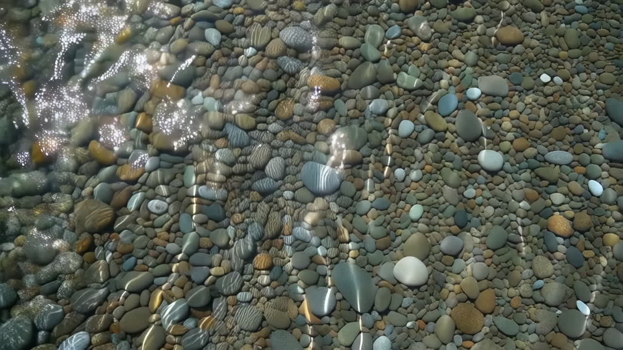 Smooth Pebbles Under Clear Water with Sunlight Reflections