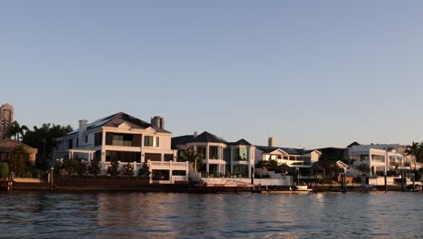 waterfront houses at sunset with calm waters