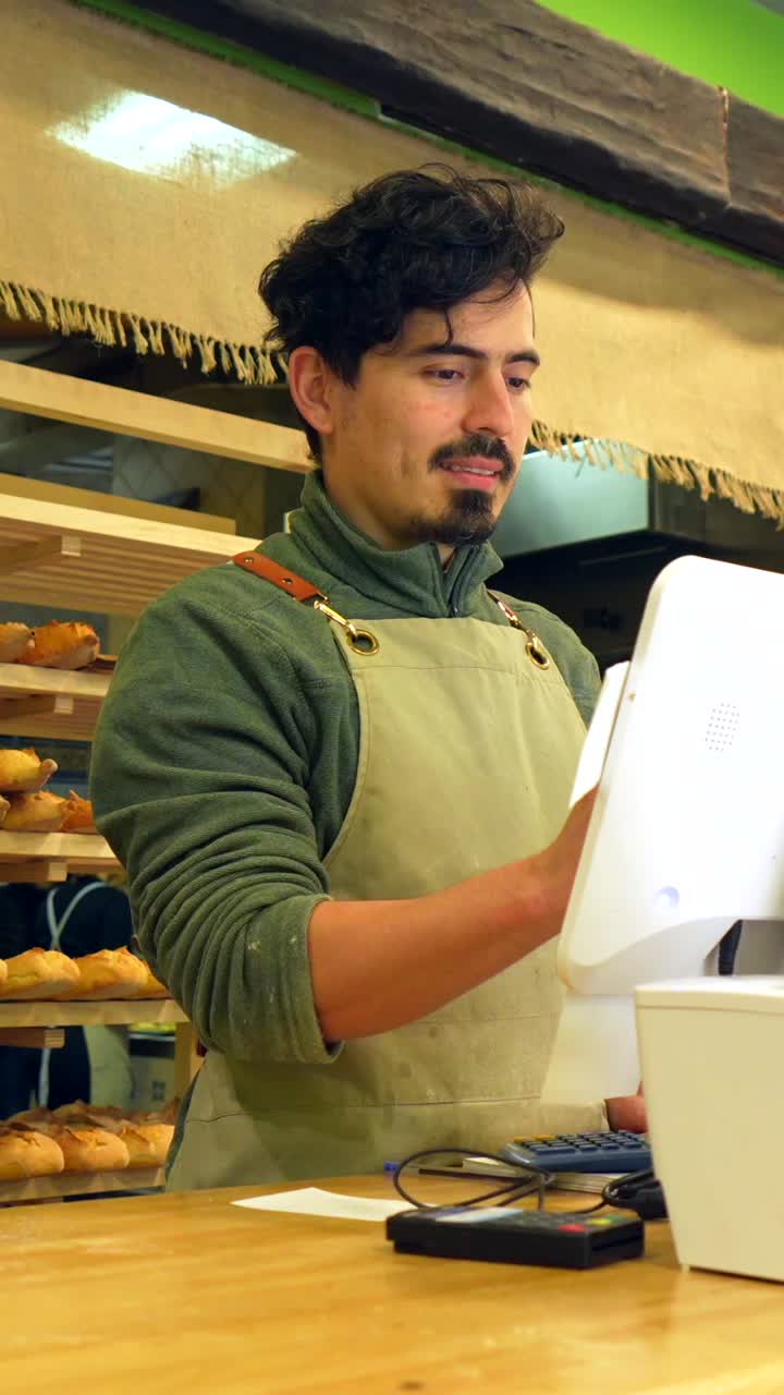 Man working at a bakery counter