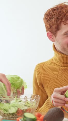 people preparing and enjoying a fresh salad