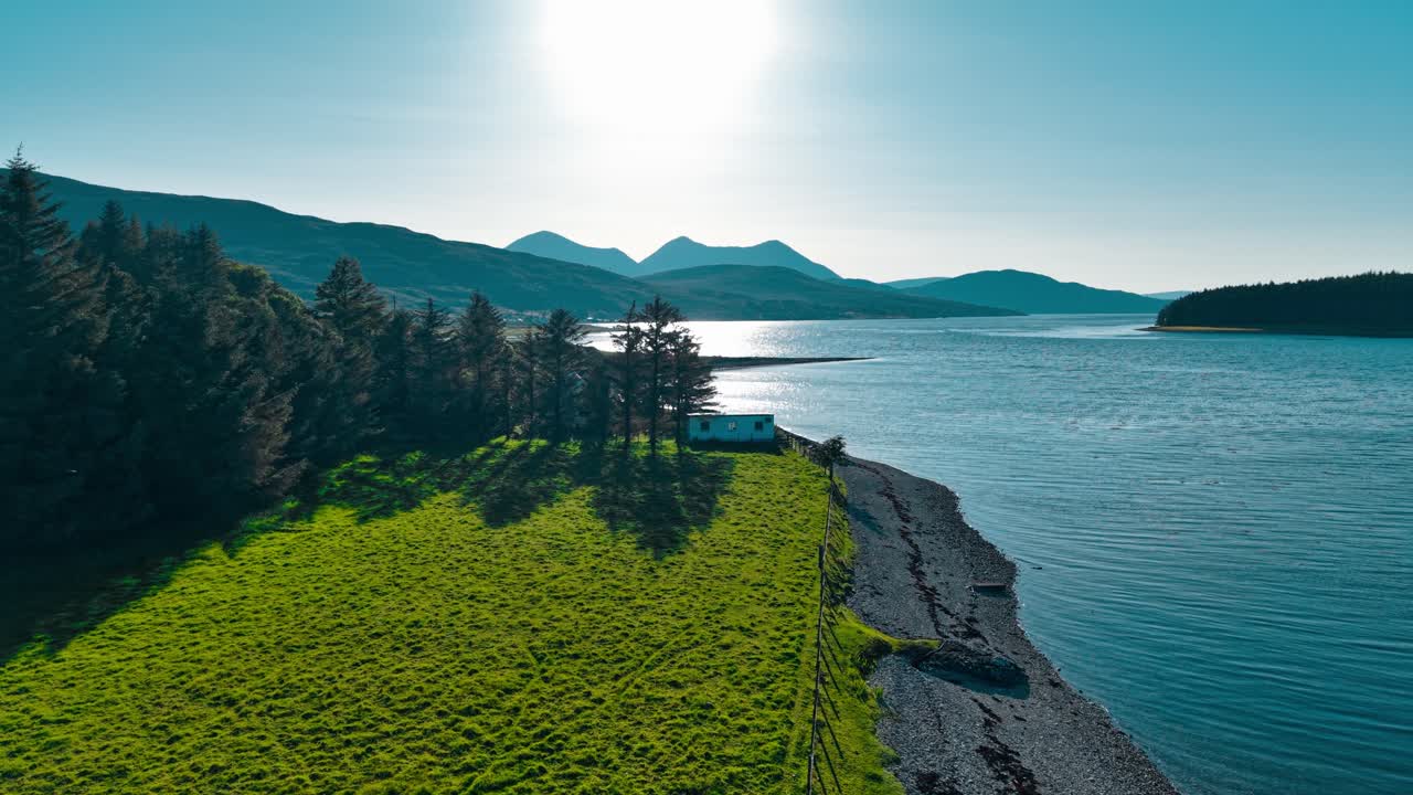 Scenic Coastal Landscape with Cottage and Mountains