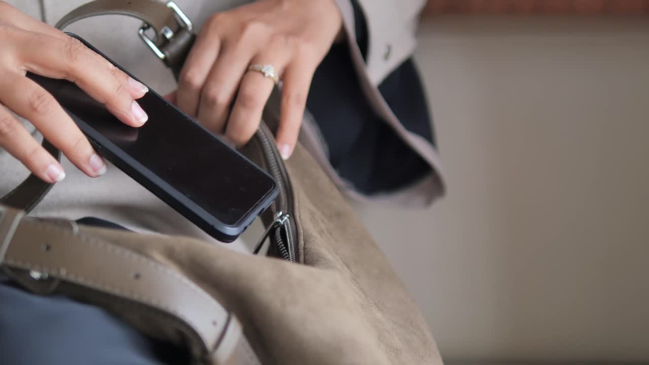 Woman opening a handbag