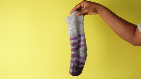 dirty sock held by hand