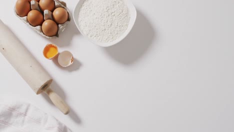 video of baking ingredients and tools lying on white surface