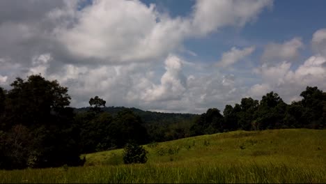 Landscape-in-Khao-Yai-National-Park,-Trees-and-Mountains-with-fluffy-big-Clouds-Casting-Shadows