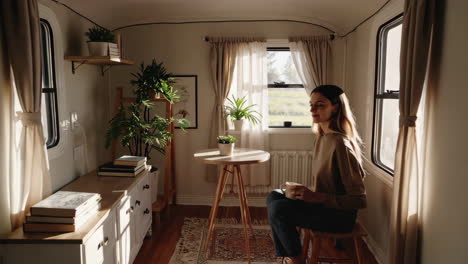 woman drinking coffee by the window