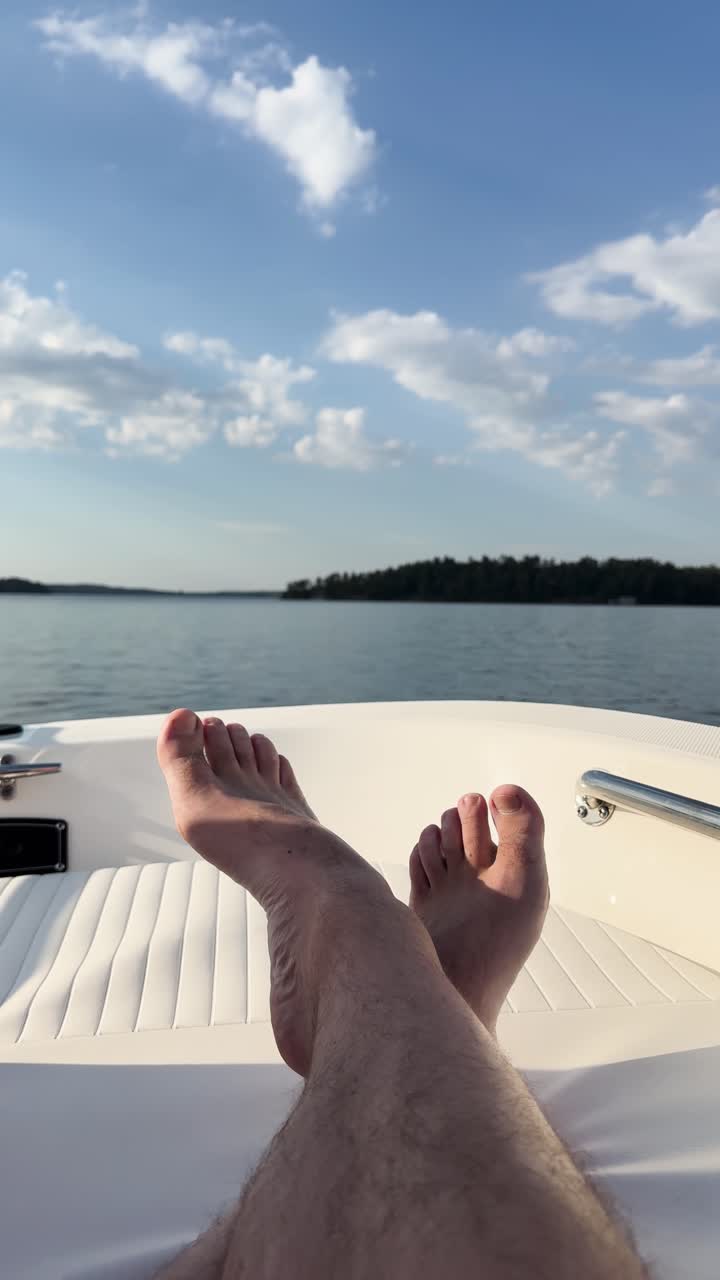 Scenic POV of person resting on yacht over calm lake in Muskoka Ontario Canada, summer travel and serenity