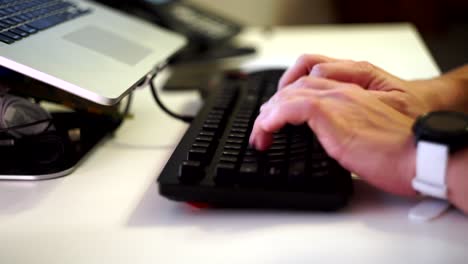 Typing-on-a-black-mechanical-keyboard-in-modern-office