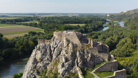 cinematic drone footage of hrad devin castle, rotating aerial shot