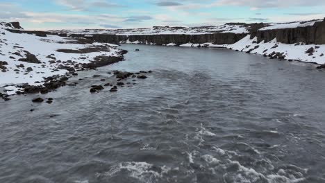 a drone's aerial dance over the river of dettifoss waterfall in iceland unveils a mesmerizing sight