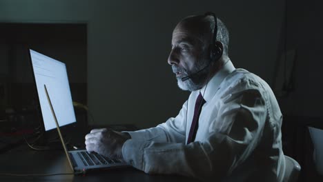 Man-in-headset-using-laptop