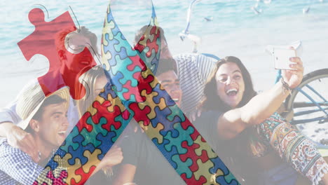 animation of colourful puzzle pieces ribbon over happy friends at summer beach party