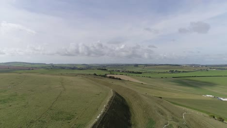 Aerial-tracking-slowly-west-above-the-northern-ramparts-of-Maiden-Castle