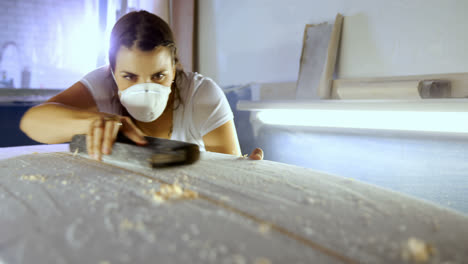 woman making surfboard at workshop 4k