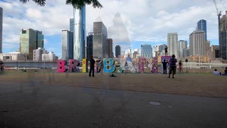 wide shot of the people climbing brisbane sign, time-lapse