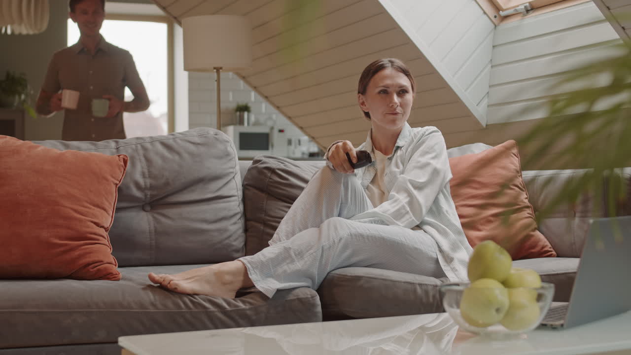 Man Bringing Coffee to Wife on Couch