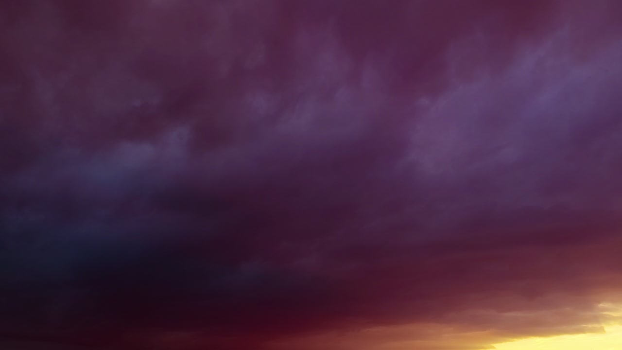 Colorful romantic sunset clouds bg moving - loop video
