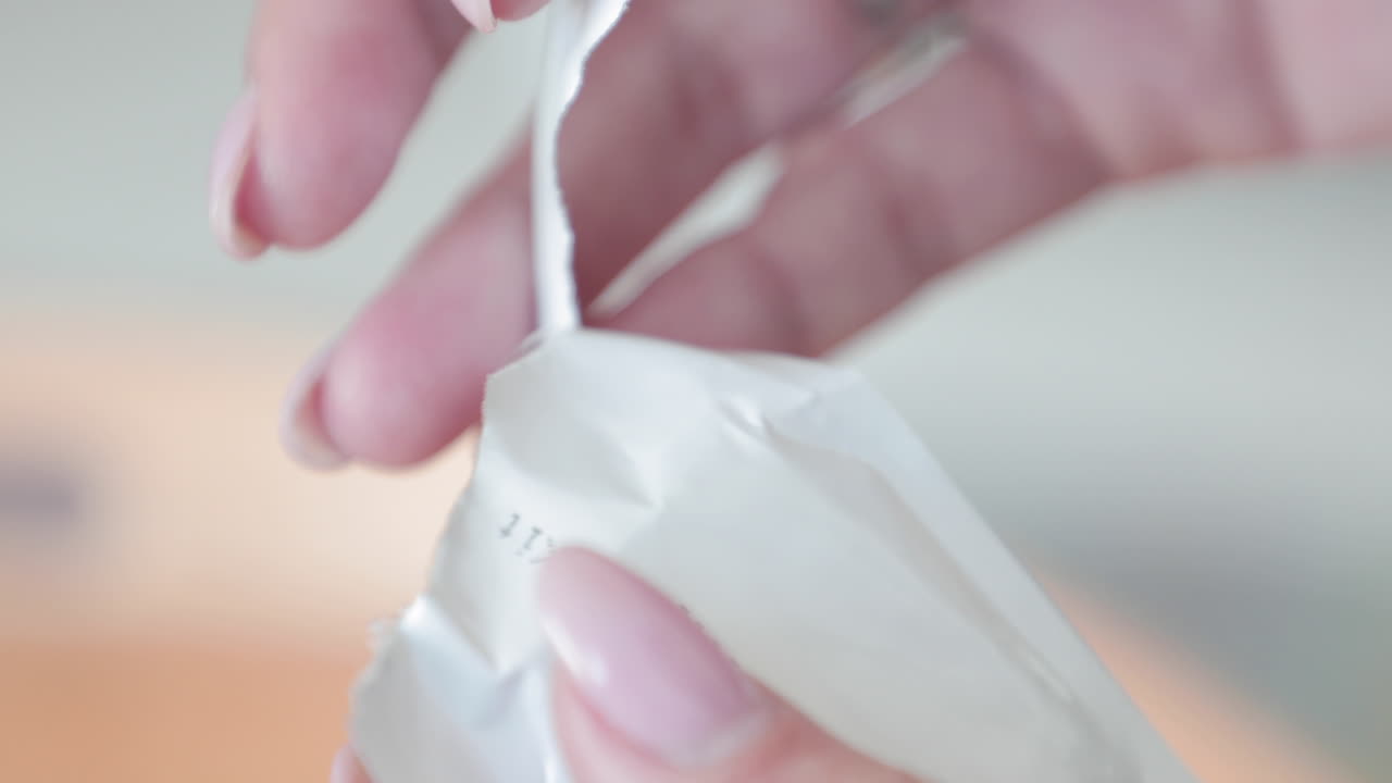 женская рука срывает упаковку с набором для экспресс-диагностики covid-19