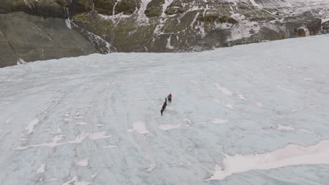 Aerial-view-over-people-hiking-on-the-ice-surface-of-Virkisjokull-glacier,-Iceland