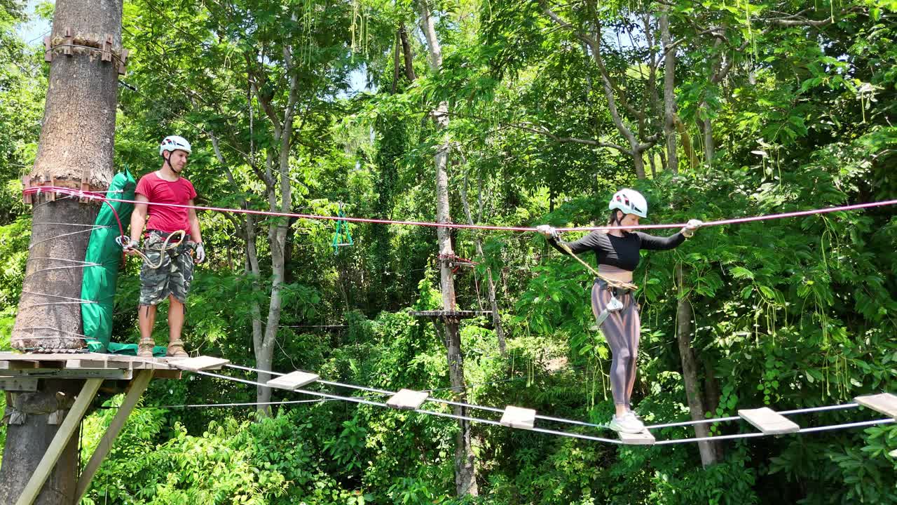 Couple enjoying a zipline adventure in a lush forest