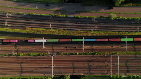 freight train traveling through the railway in barendrecht, netherlands. - aerial shot
