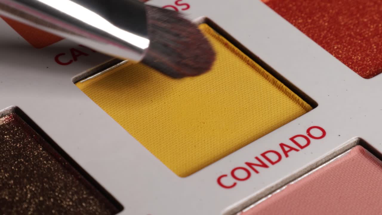 Shot of brush using eyeshadow from palette (condado).