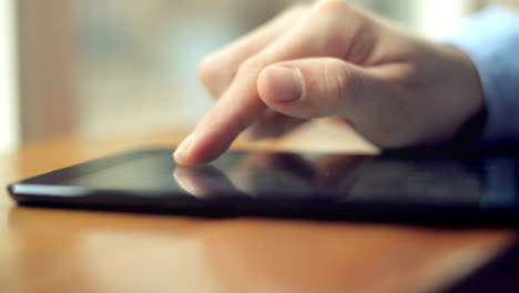 hombre de negocios usando una pantalla táctil de computadora de tableta en un café