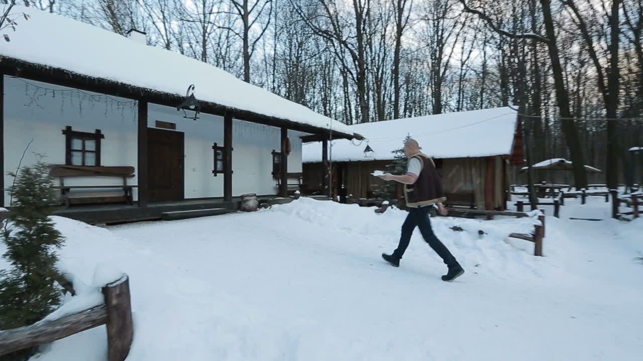 Man bears dishes. Waiter bears dishes across the restaurant street