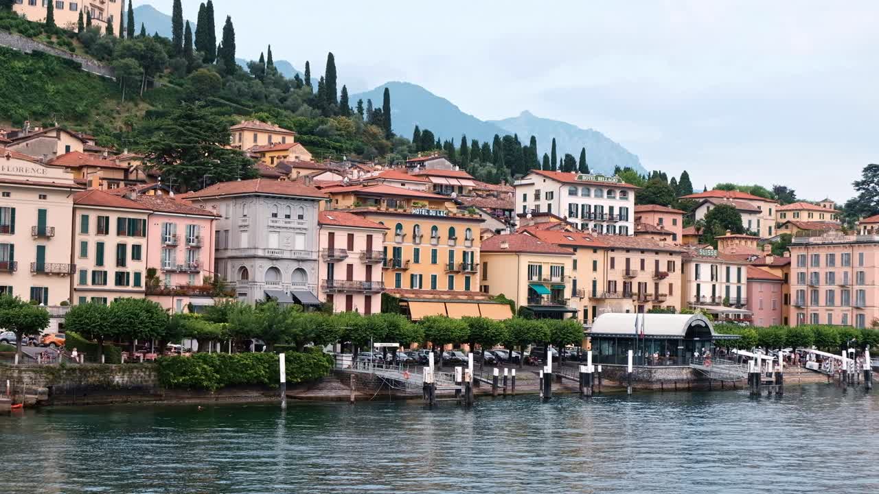 LOMBARDY, ITALY - AUGUST 02, 2018: Cinematic shot of Bellagio town, Como lake and mountains from a boat