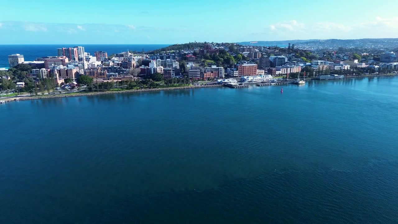 Paesaggio aereo ripreso da drone del porto della città di Newcastle con edifici residenziali, appartamenti e negozi commerciali lungo il lungomare di Honeysuckle vicino al fiume Hunter, turismo in Australia