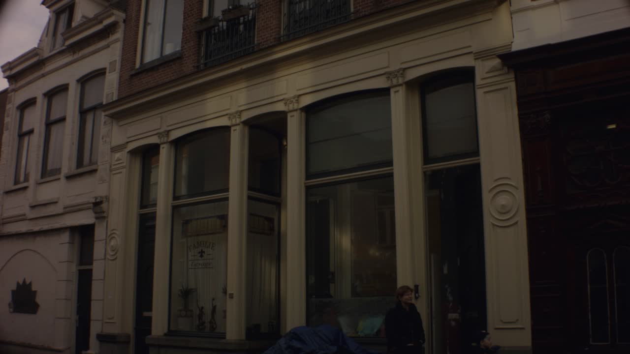 Old Ijmuiden - Netherland - January 21st 2019 : straight down motion view of a classical vintage building on street in dutch neighborhood close to harbor during winter