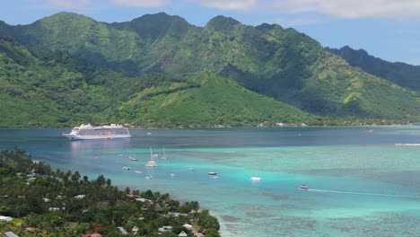 Cinematic-aerial-drone-flight-around-mountains-of-Moorea-in-French-Polynesia-with-anchored-cruise-ship-in-the-foreground