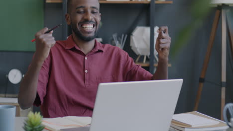 man working on a laptop in an office