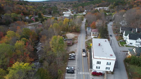 vehicle towing boat on road in lake sunapee neighborhood, tracking aerial view