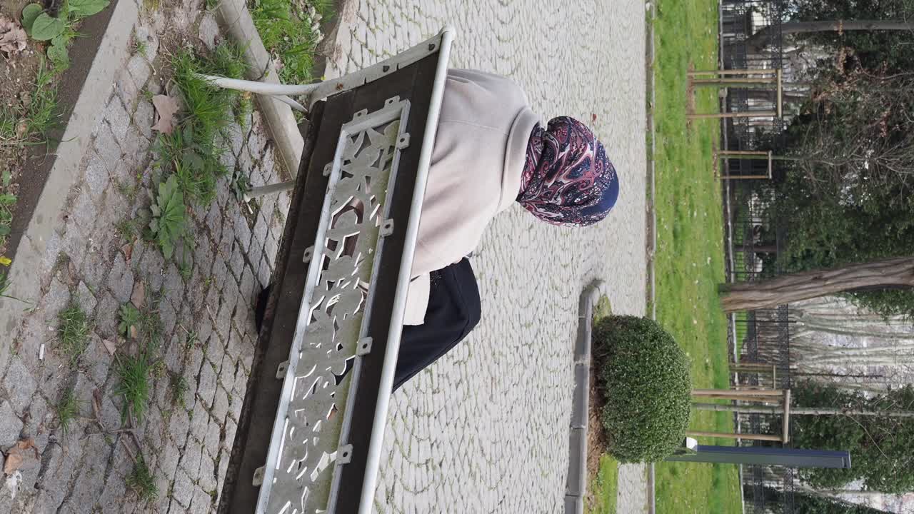 Woman sitting on park bench