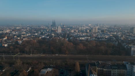 Establishing-drone-shot-of-Cologne-in-winter---Aerial-4k-panorama-view-of-Köln,-Germany-with-cathedral-in-front-of-a-blue-sky