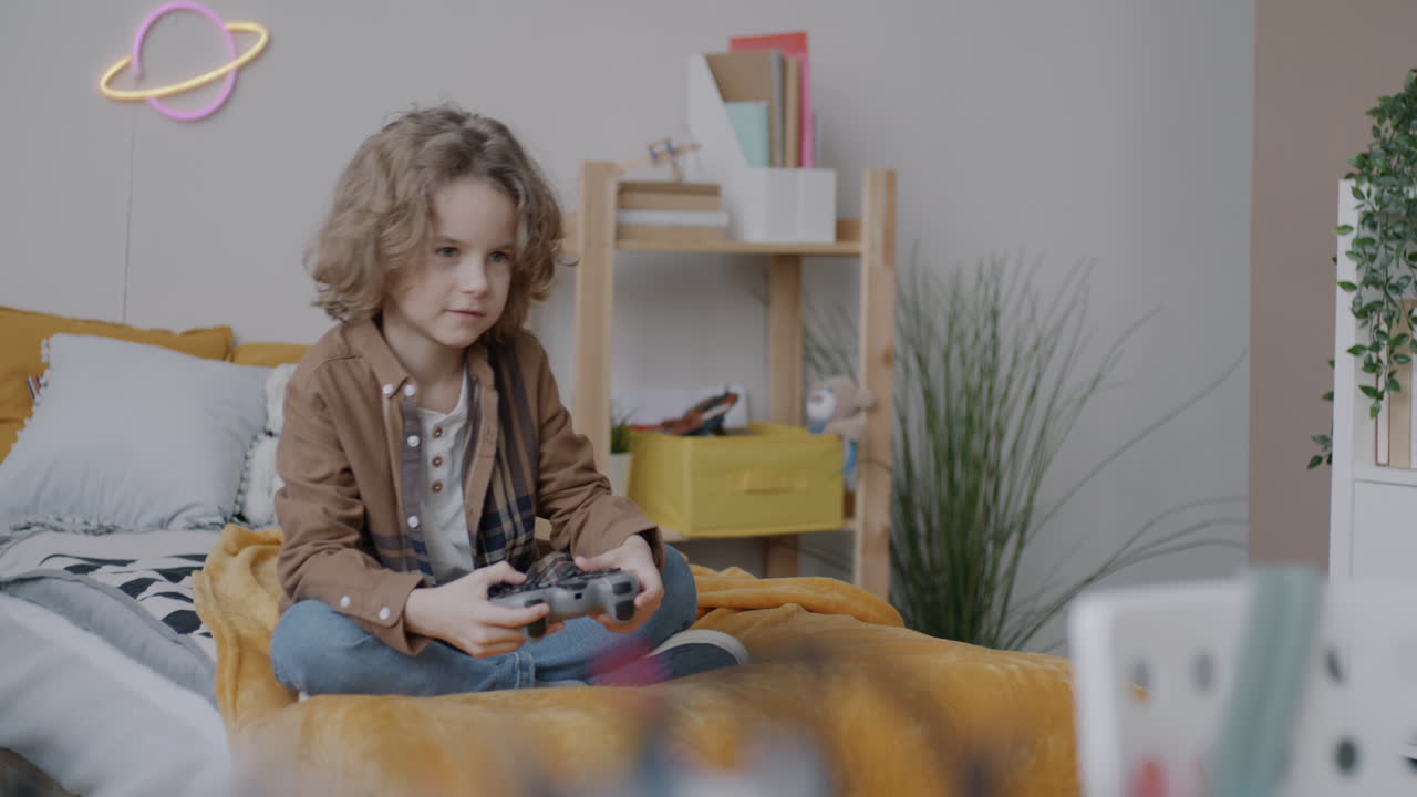 Boy Playing Video Games in His Bedroom