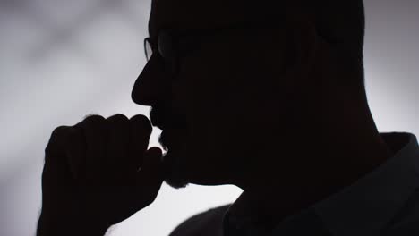 close up silhouette of depressed mature man struggling with mental health in slow motion