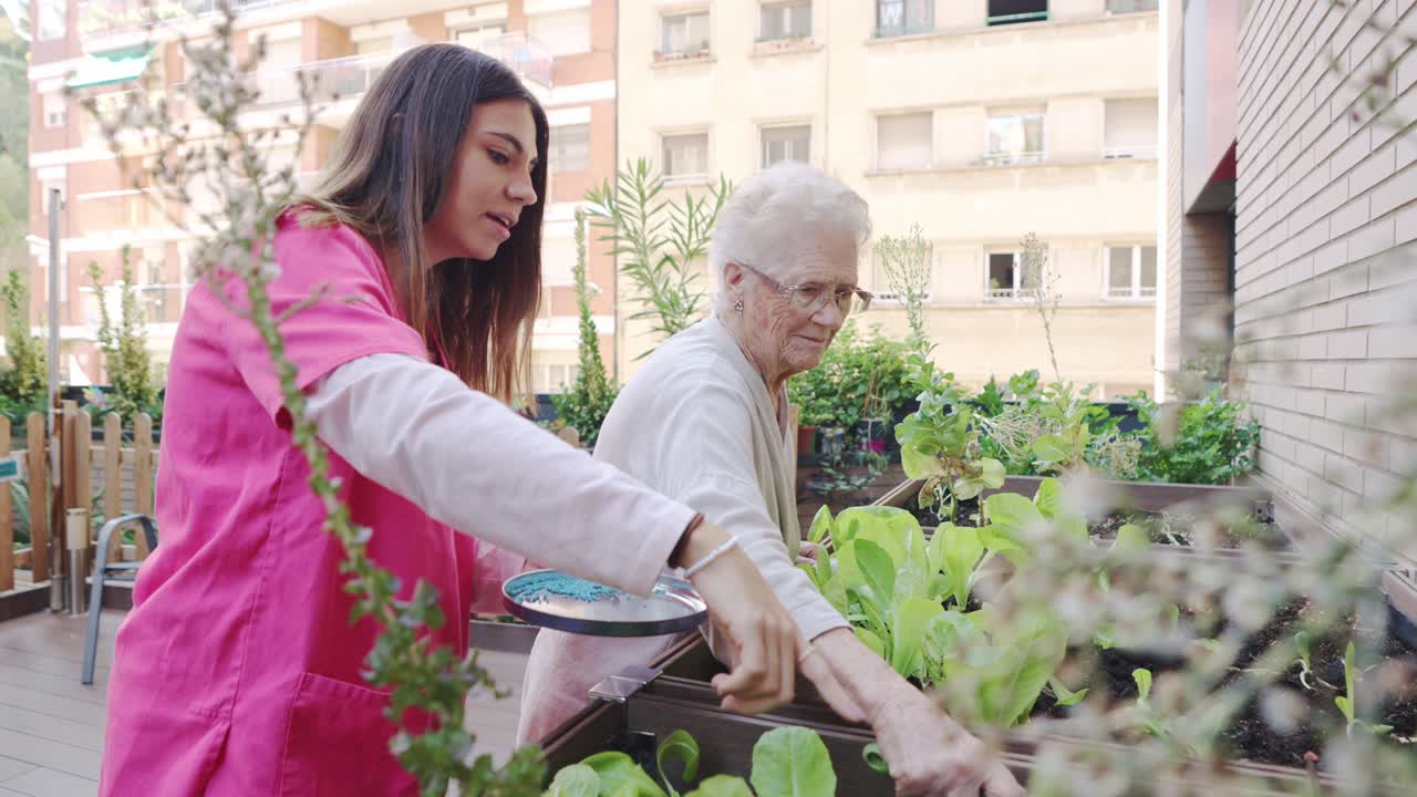 Senior woman gardening with caregiver